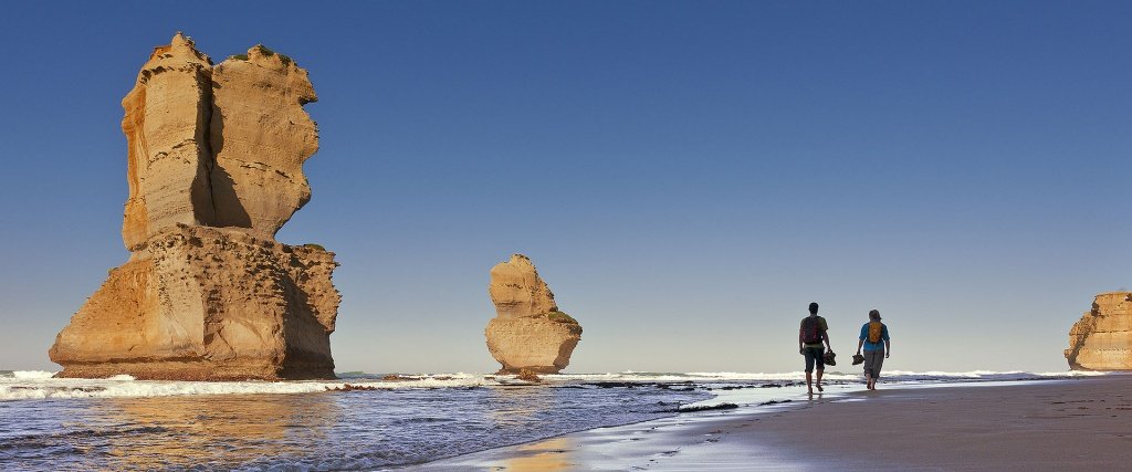 two_figures_walking_on_seashore